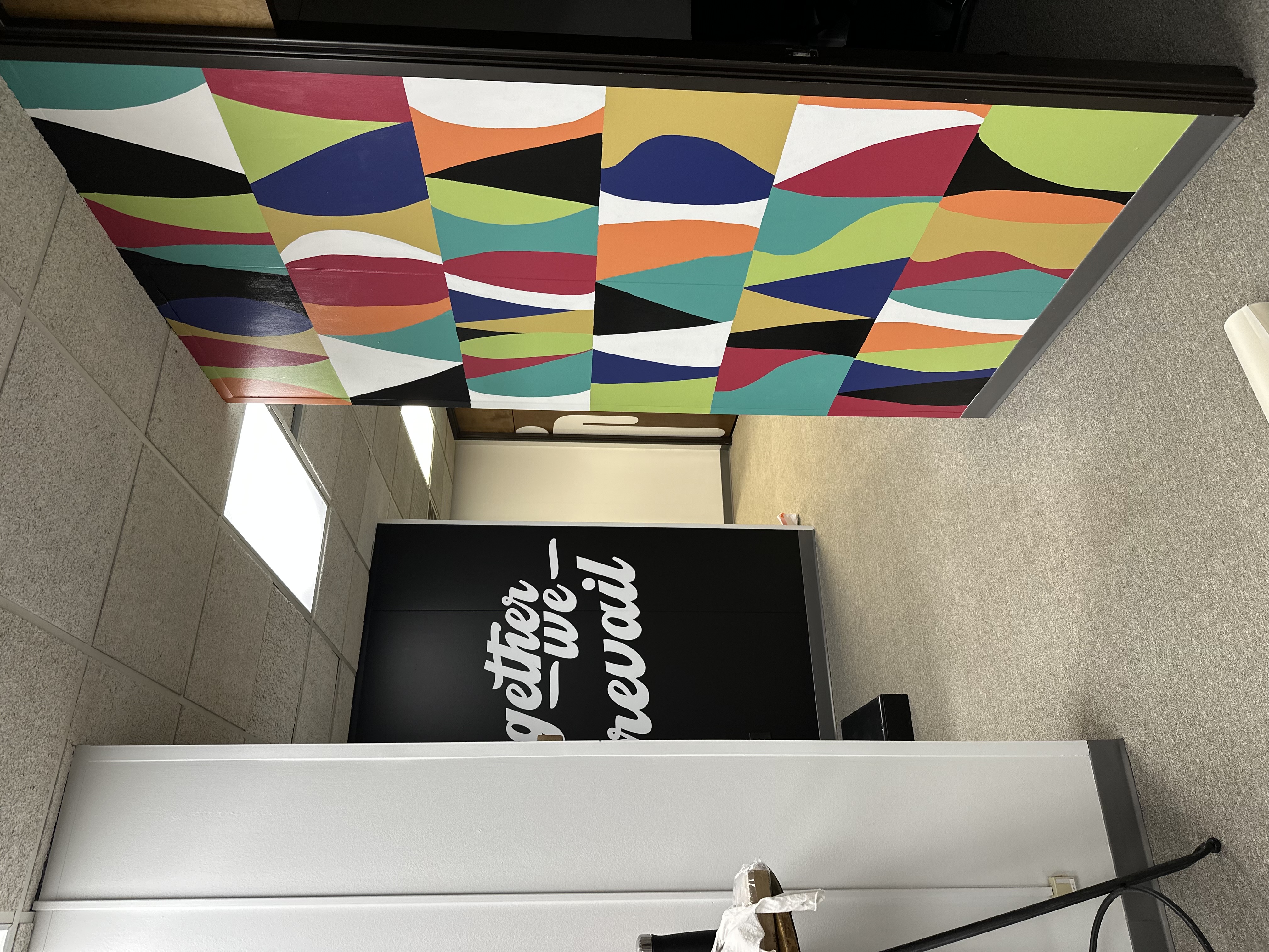 Colorful abstract mural wall with Together We Prevail sign